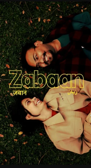 “Zabaan” in outlined yellow lettering across a photo of two people lying on grass among fallen leaves, with the word repeated in Devanagari (ज़बान) and in Urdu script (زبان) on either side.